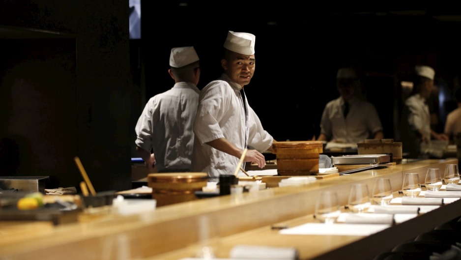 在厨师餐桌旁用餐的人分次用餐，就好像每人都有一场演出的门票。